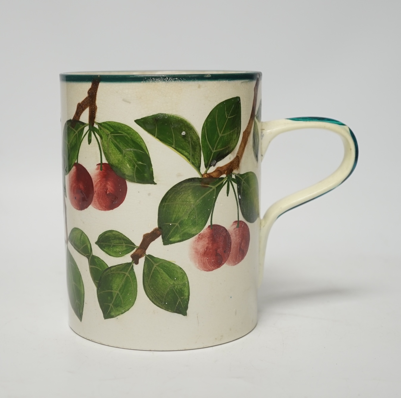 A Wemyss mug with cherry decoration (restored a.f.), 14cm high